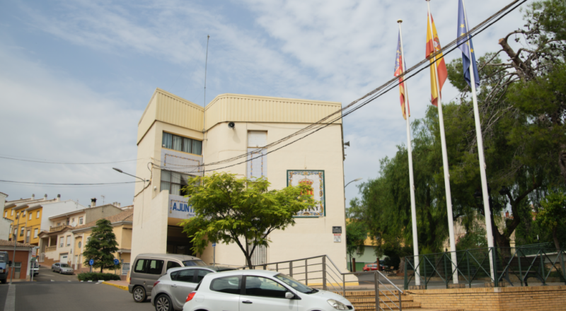 Entrada a l'ajuntament des del carrer amb escales i una rampa amb barana per a persones amb mobilitat reduïda.